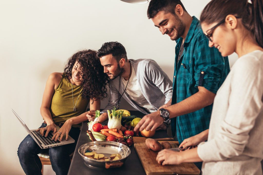 Young Group Of Friends Preparing Vegetable Meal And Making Fun.