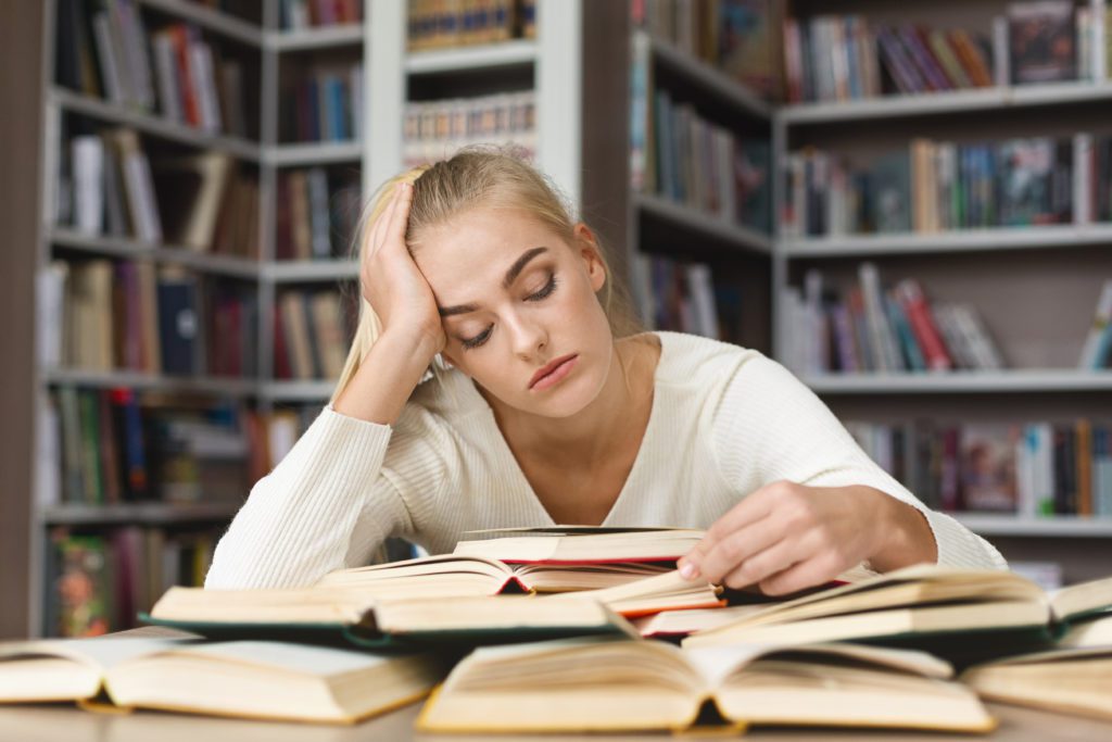 Super,Tired,Caucasian,Girl,Reading,Book,,Leaning,On,Her,Elbow,