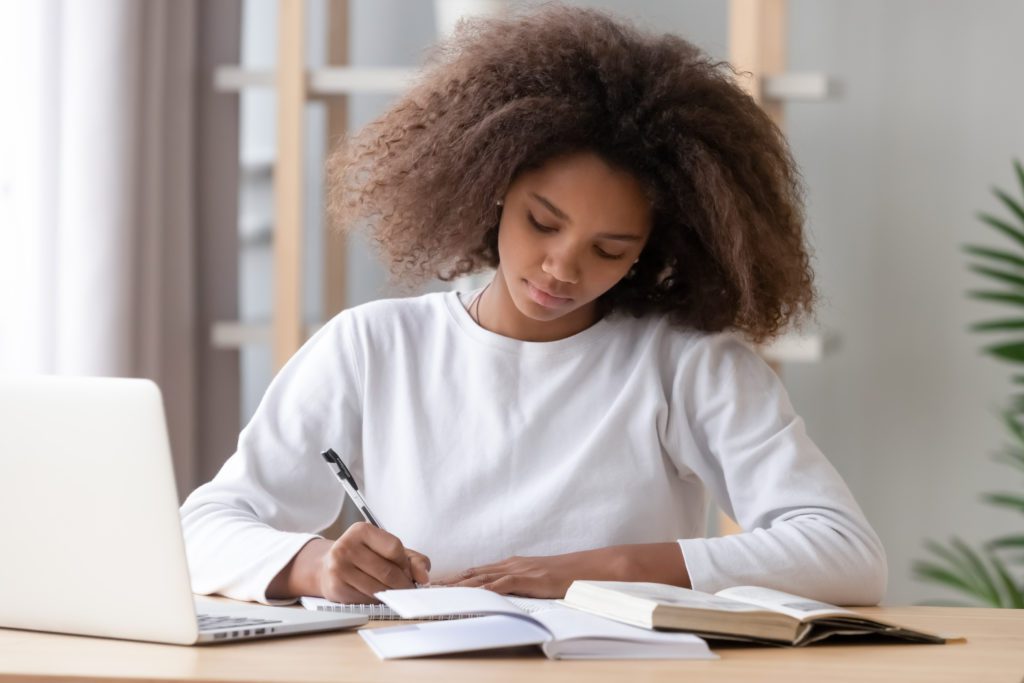 Focused,African,American,School,Girl,Studying,With,Books,Laptop,Preparing