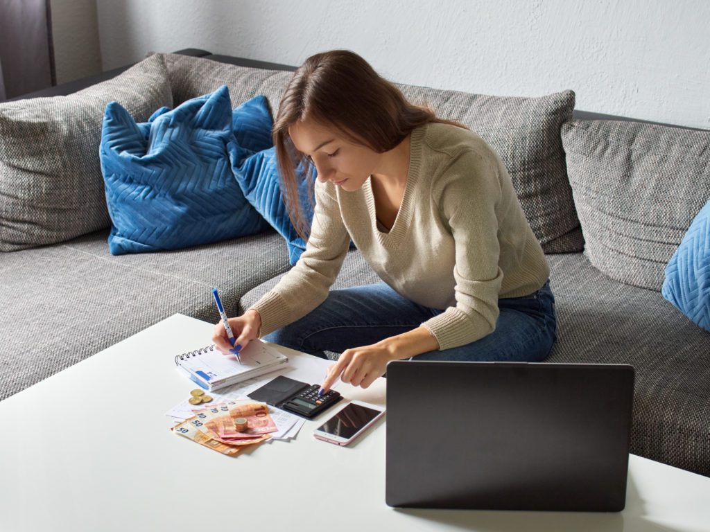 Young,Woman,Sitting,On,The,Couch,In,The,Living,Room