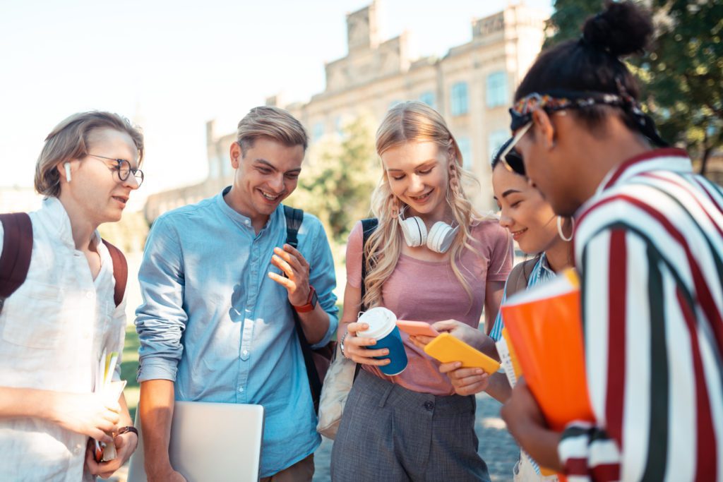 Different,Schedules.,Two,Smiling,Girls,Looking,At,Their,Smartphones,ComparingDifferent,Schedules.,Two,Smiling,Girls,Looking,At,Their,Smartphones,Comparing