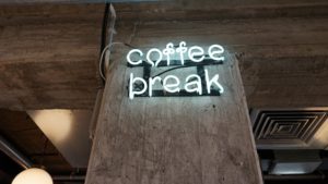 A neon sign saying "coffee break"
