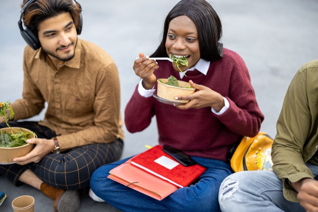 students eating a salad on lunch break