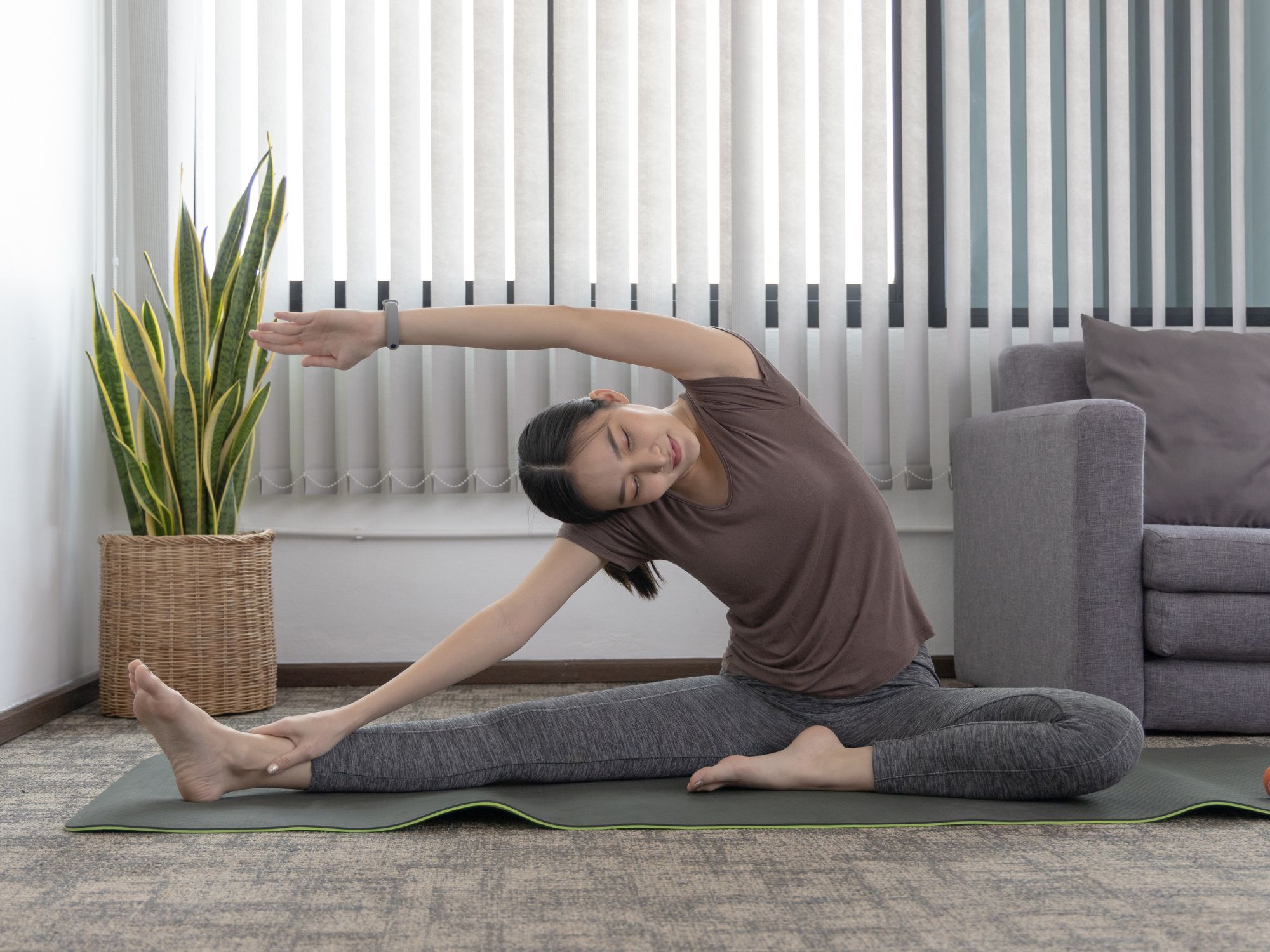 female student on the floor stretching out in living room