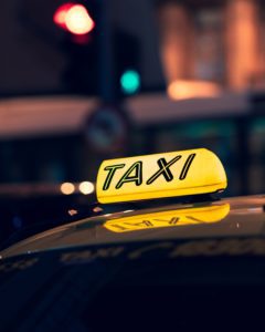 a yellow taxi sign