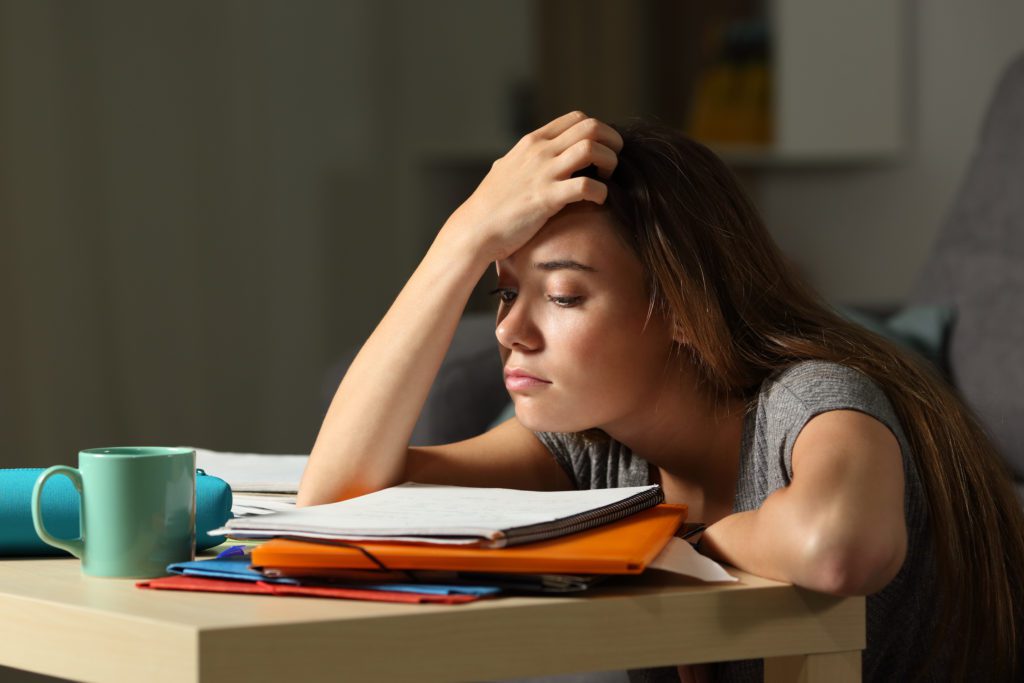 Tired female student trying to studyy In The Night At Home