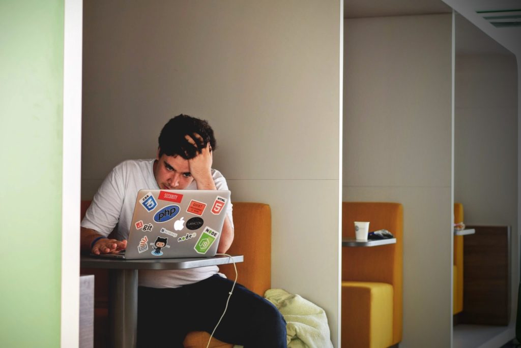 student looking at a laptop with anxiety