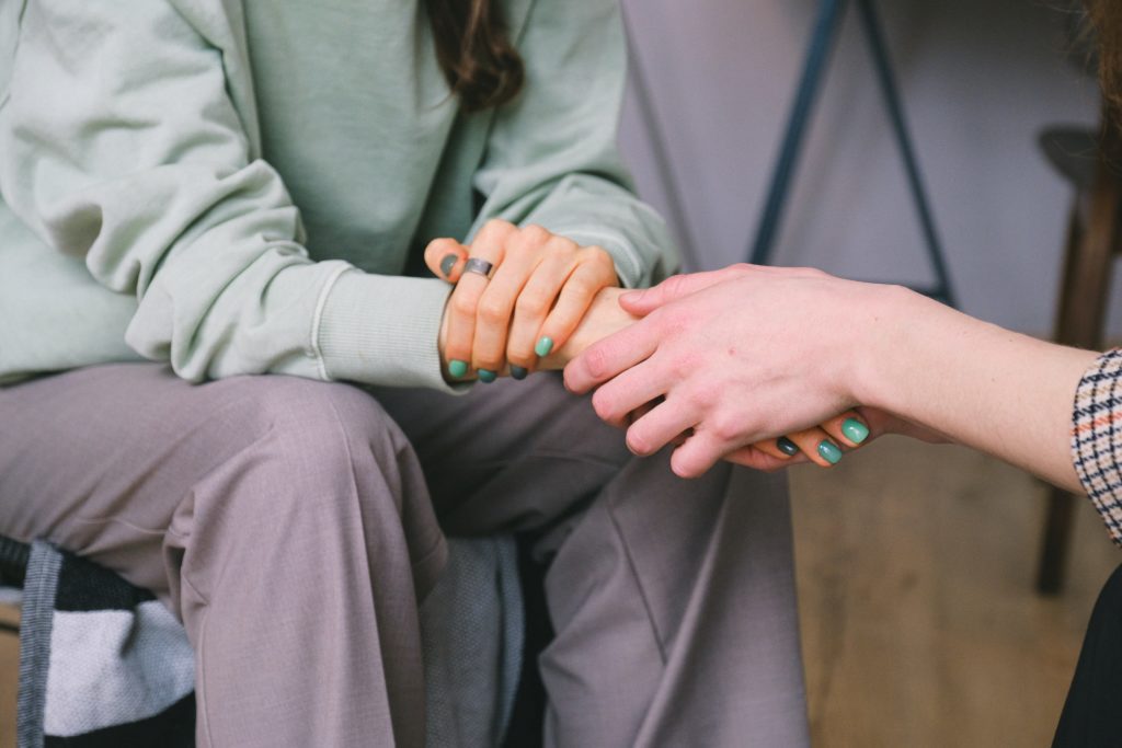 person holding anothers hand to help with anxiety