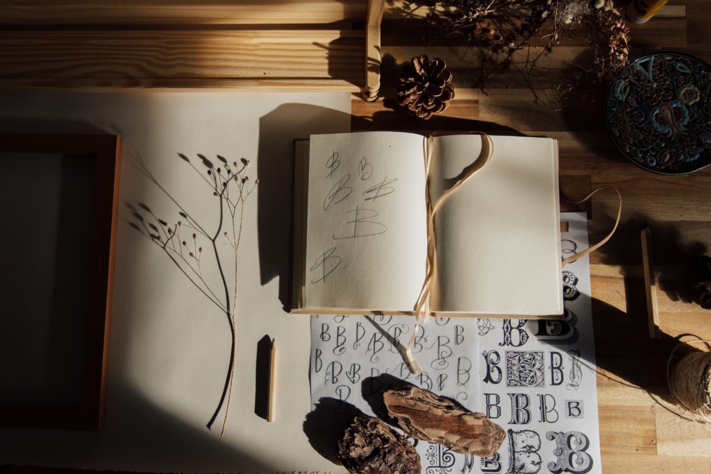 open notebook on desk with lettering