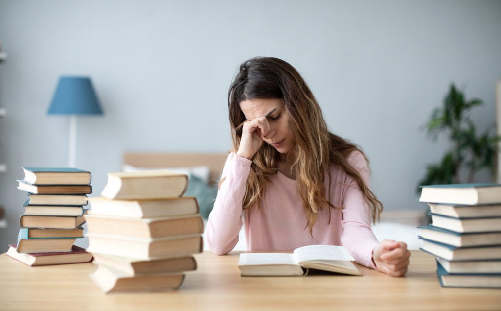 Sad,Young,Woman,With,Books,Sit,At,Work,Desk.,Home