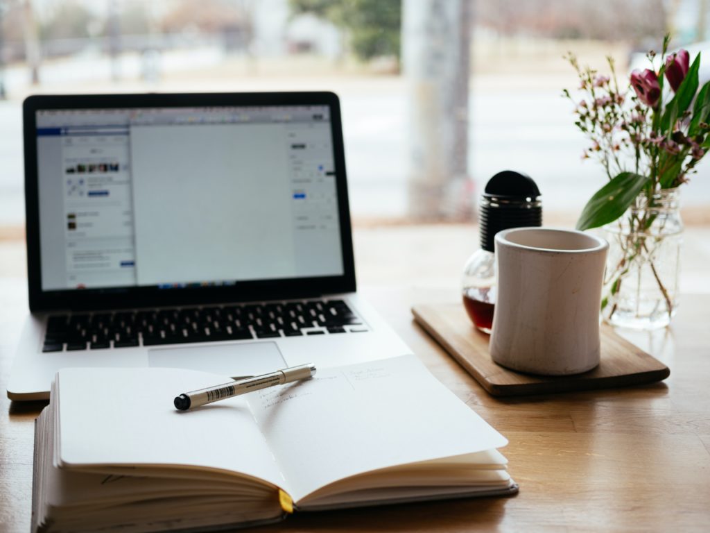 laptop and notebook on table