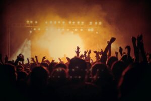 people dancing at a party with lights in the background